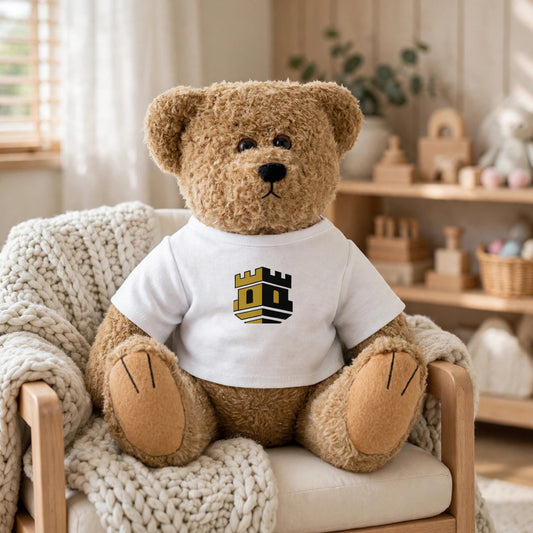 Blockhouse Teddy Bear — Plush with Logo Tee — staged in a nursery