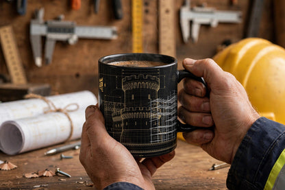 Builder's Mug — Fortress Blueprint — modeled photo, held in hand