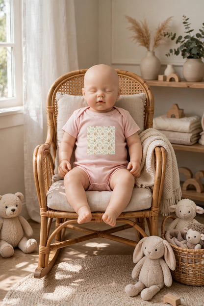 Castle Companions infant bodysuit in pink with a storybook castle and animal print, worn in a nursery rocking chair
