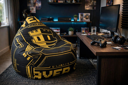 Controller Chair bean bag chair with black and gold gaming graphics set up beside a gaming desk