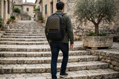 Dragon Scale backpack with flat gold scale print worn by a man climbing stone steps in a historic town