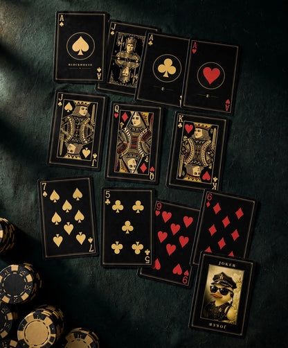Fortress Deck card faces laid out on a poker table — custom court cards, aces, and the security-guard duck jokers