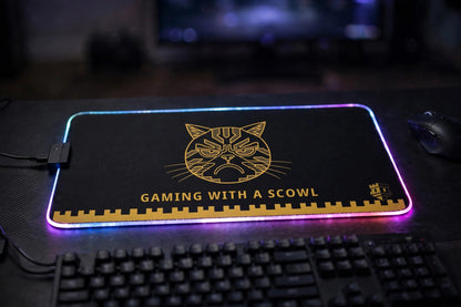 Gaming with a Scowl LED mouse pad lit up at a gaming desk — RGB LED edge glowing
