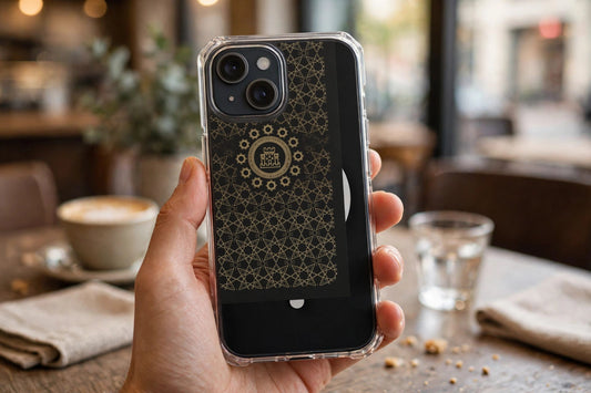 Islamic Geometric Tiles clear phone case held in hand at a cafe table