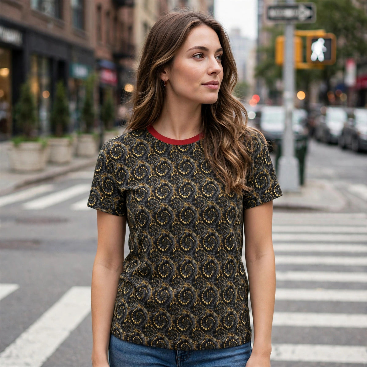 Woman wearing the black and gold spiral pattern Metro tee with red collar at a city crosswalk