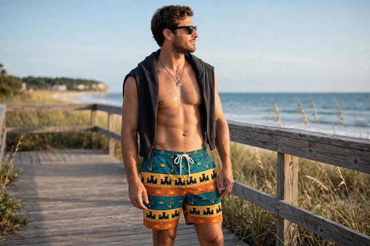 Man wearing the retro coastal swim shorts on a beach boardwalk with the ocean behind him