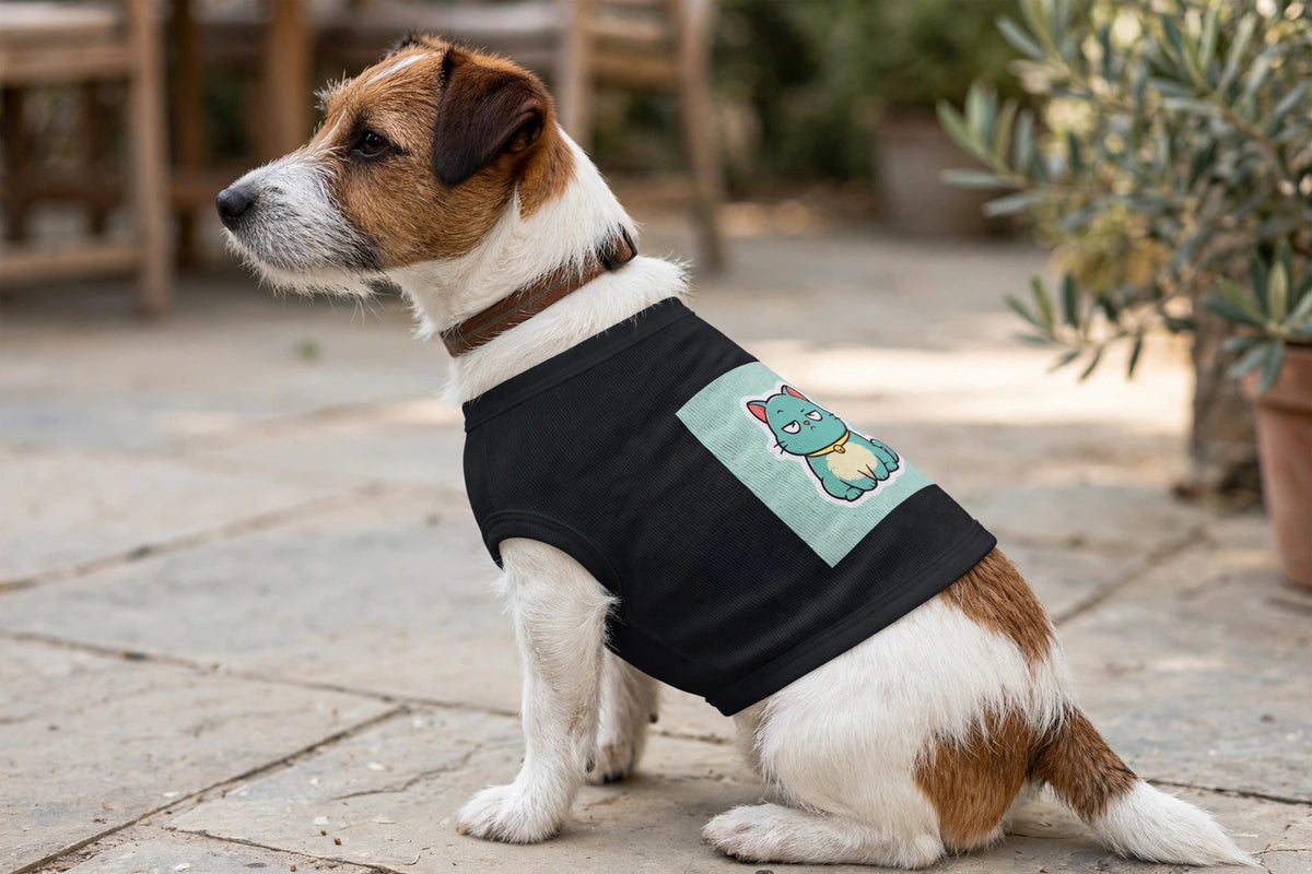 A small dog wearing the black Scowl pet tank on a patio, showing the grumpy teal cat print.