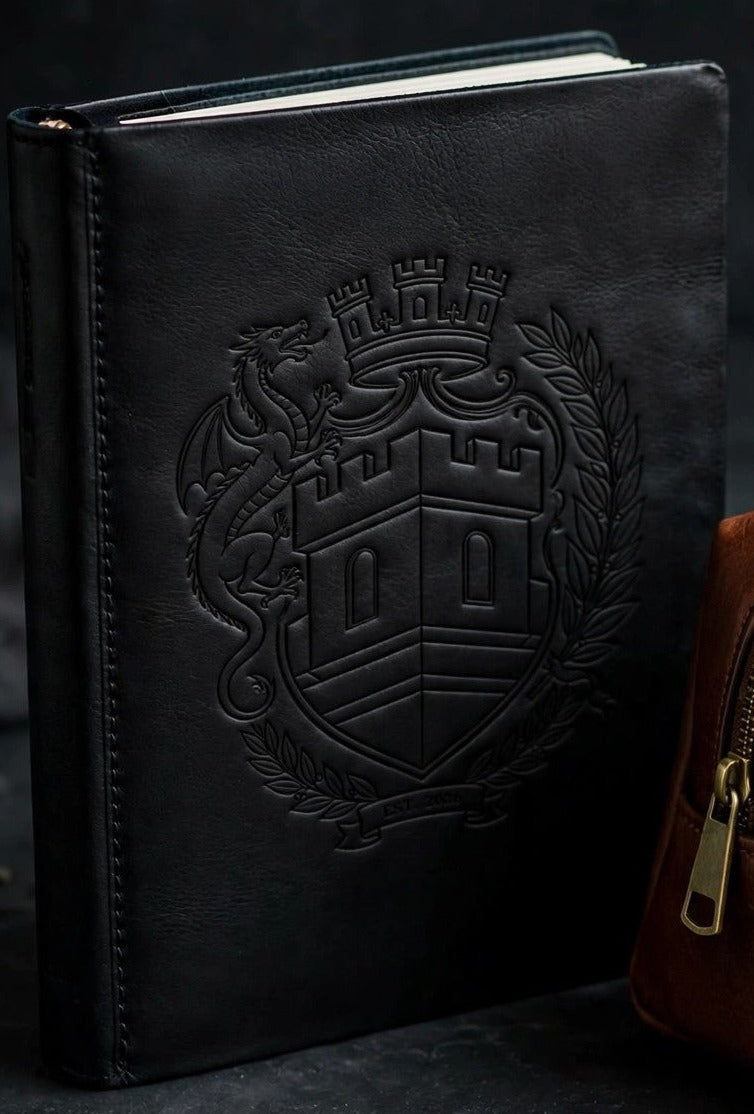 Sovereign Crest black engraved leather journal standing on dark slate